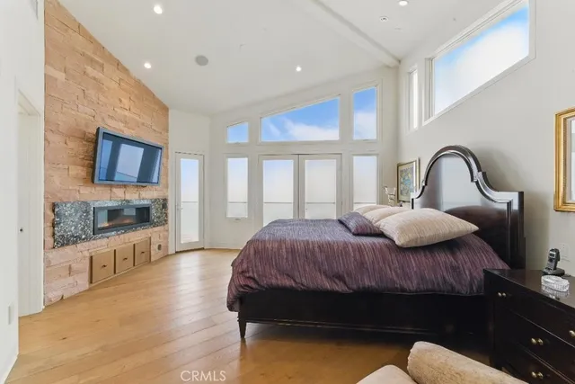 a spacious bedroom with a bed and a flat screen tv