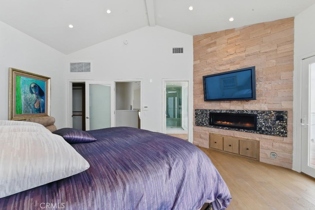 2501 Barrymore Drive Malibu, CA 90265 - Photo 34 of 54 a spacious bedroom with a bed and a flat screen tv