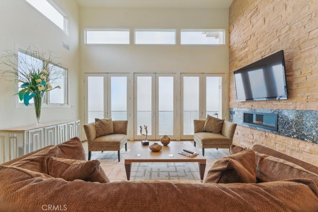 2501 Barrymore Drive Malibu, CA 90265 - Photo 4 of 54 a living room with furniture and a floor to ceiling window