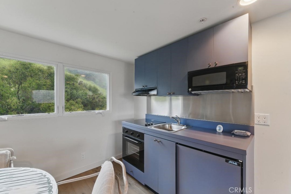 2501 Barrymore Drive Malibu, CA 90265 - Photo 47 of 54 a kitchen with a sink cabinets and a window