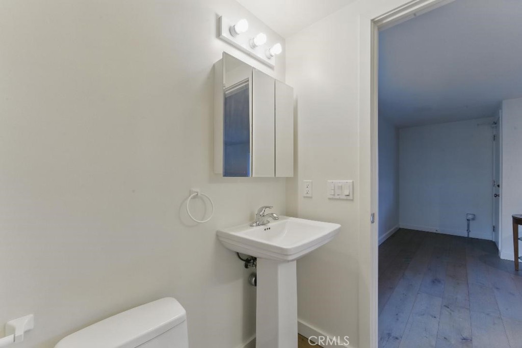 2501 Barrymore Drive Malibu, CA 90265 - Photo 49 of 54 a bathroom with a sink toilet and mirror