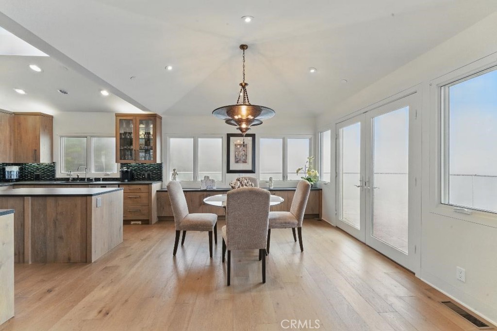 2501 Barrymore Drive Malibu, CA 90265 - Photo 10 of 54 a view of a dining room with furniture window and wooden floor
