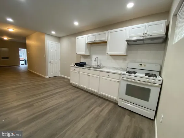 a kitchen with stainless steel appliances granite countertop a stove and a sink