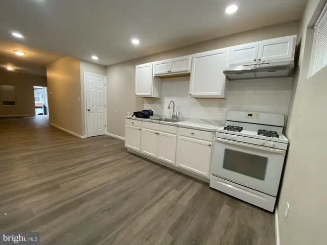 a kitchen with stainless steel appliances granite countertop a stove and a sink