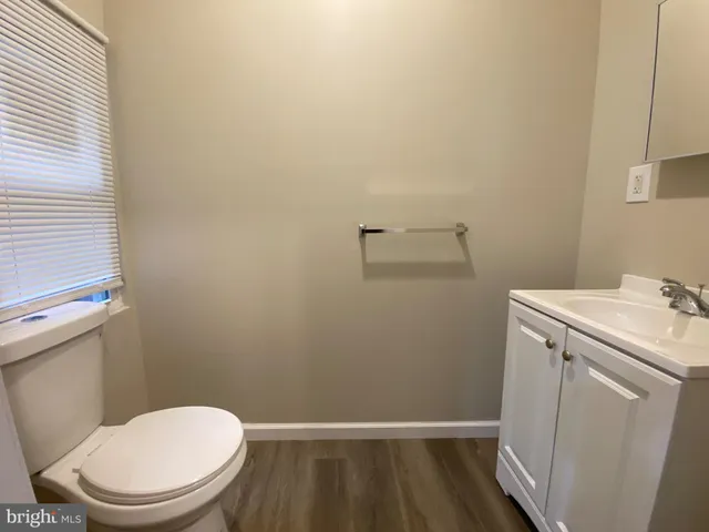 a white toilet sitting next to a small sink