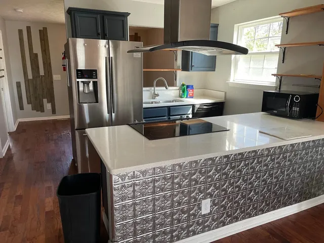 a kitchen with stainless steel appliances wooden cabinets a refrigerator and a stove