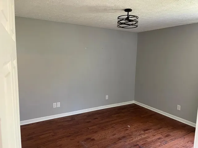 a view of a small space with wooden floor