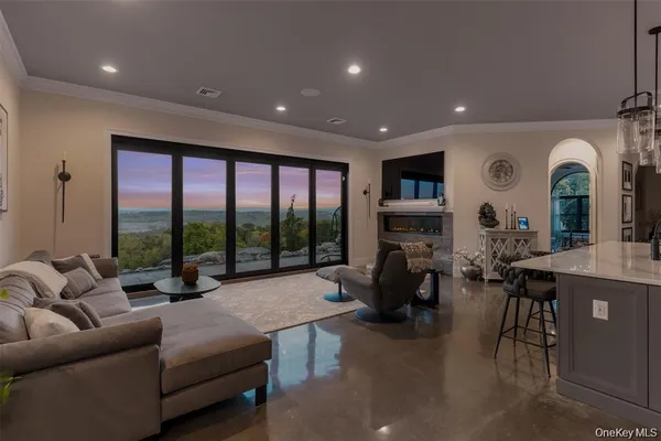 a living room with fireplace furniture and a large window