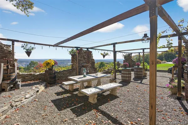 a living room with patio furniture and a floor to ceiling window