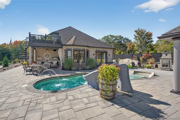 a view of a house with backyard porch and sitting area