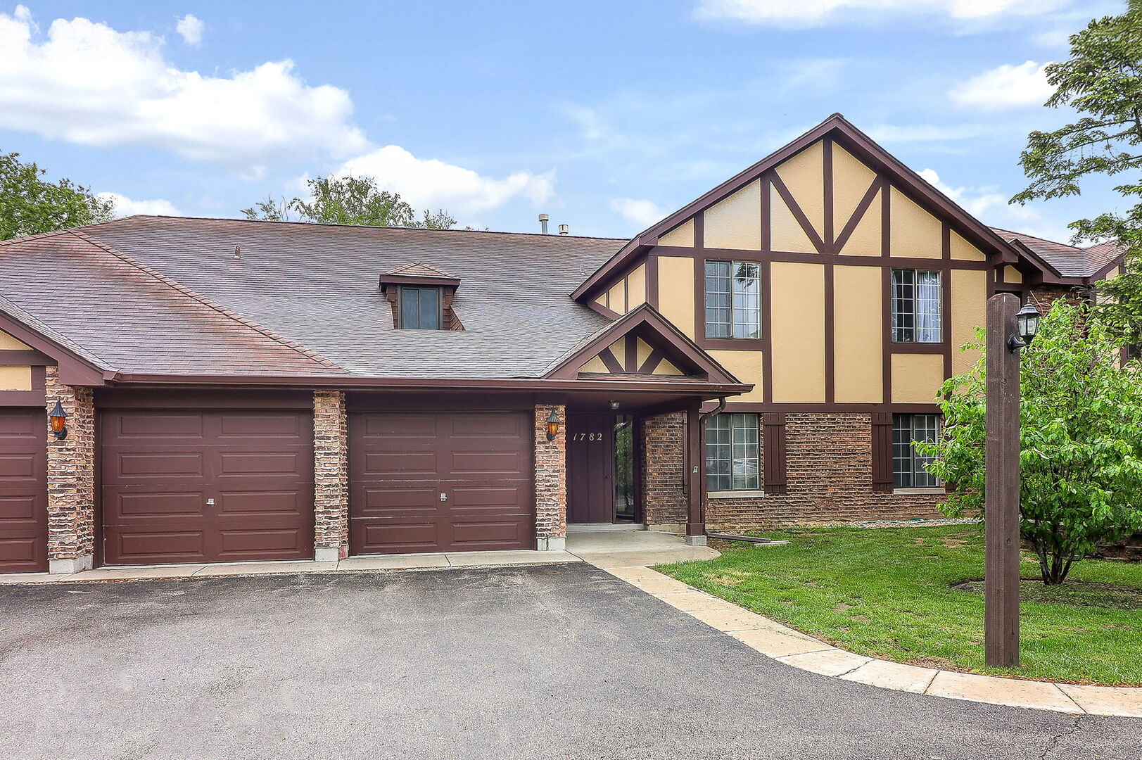 1782 Gloucester Court, Unit B Wheaton, IL 60189 - Photo 1 of 16 a front view of a house with a yard and garage