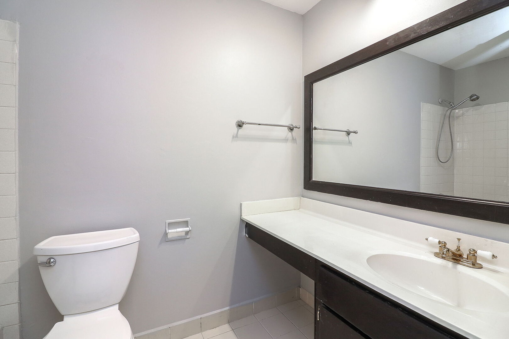 1782 Gloucester Court, Unit B Wheaton, IL 60189 - Photo 11 of 16 a bathroom with a toilet sink and mirror