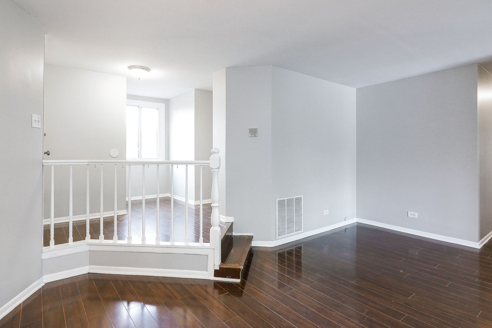 1782 Gloucester Court, Unit B Wheaton, IL 60189 - Photo 2 of 16 an empty room with wooden floor and windows