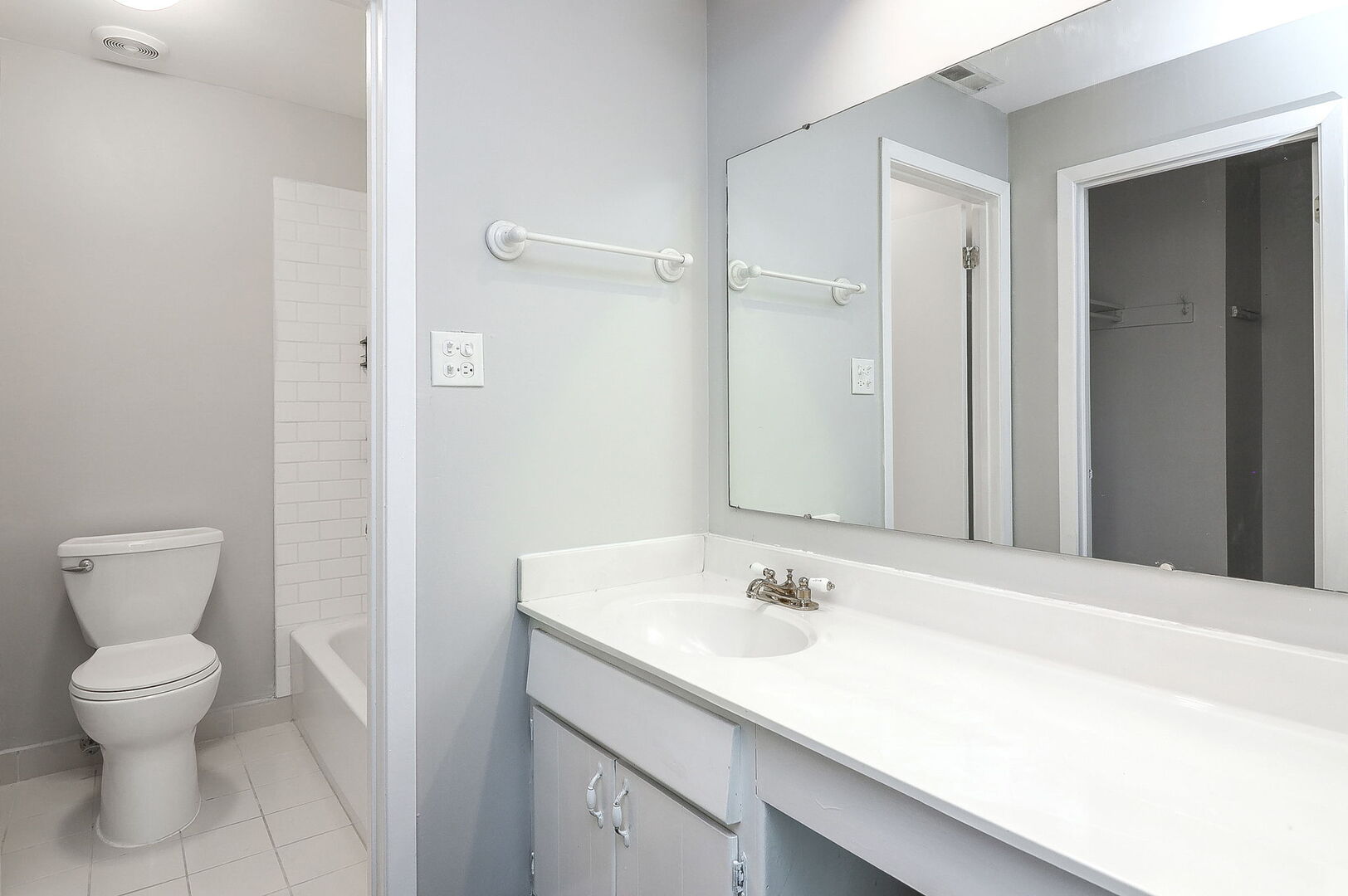 1782 Gloucester Court, Unit B Wheaton, IL 60189 - Photo 9 of 16 a bathroom with a sink toilet and a mirror