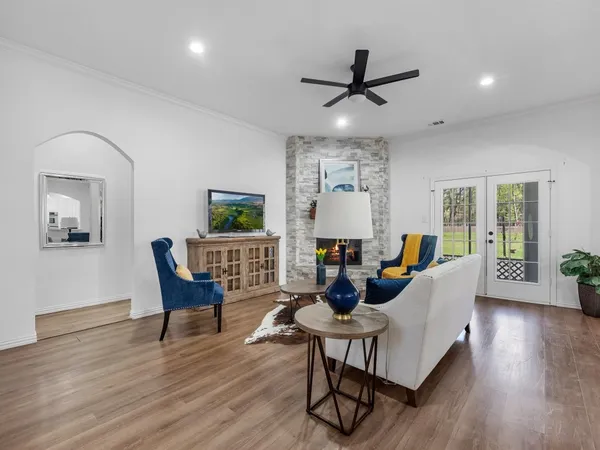 a view of a dining room with furniture a rug and wooden floor