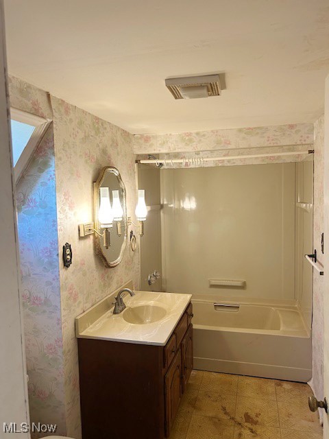 6128 Riverview Road Peninsula, OH 44264 - Photo 13 of 17 Bathroom featuring vanity, bathing tub / shower combination, wallpapered walls, and light tile patterned floors