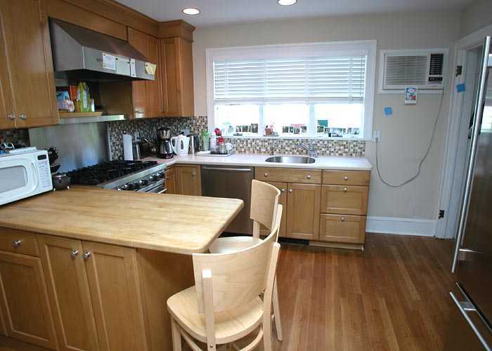 19 Miltiades Avenue Riverside, CT 06878 - Photo 3 of 5 a kitchen with kitchen island a stove a sink a refrigerator and a dining table with wooden floor