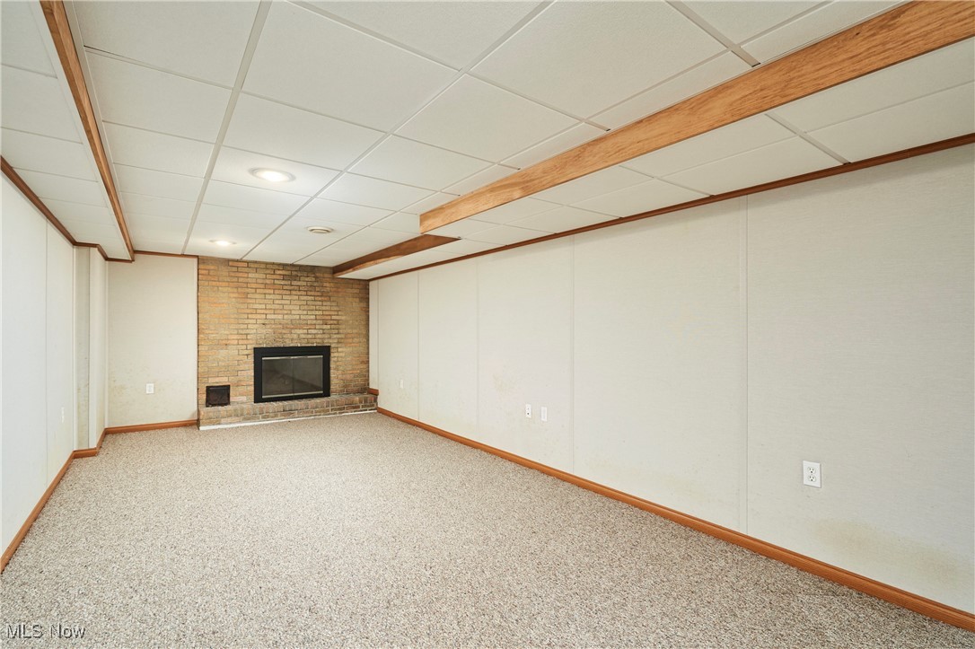 2835 Sunnybrook Road Mogadore, OH 44260 - Photo 10 of 27 Finished basement featuring a drop ceiling, a fireplace, carpet floors, and recessed lighting