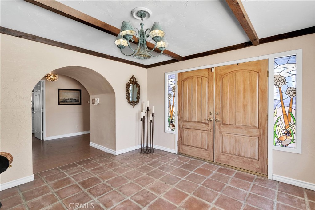 19955 Chickasaw Road Apple Valley, CA 92307 - Photo 7 of 60 a view of a hallway with entryway wooden floor and front door
