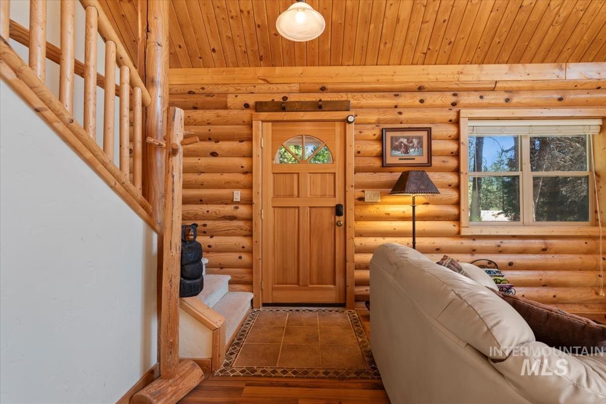 10 Elk Point Road Garden Valley, ID 83622 - Photo 9 of 42 Foyer featuring log walls and tile patterned flooring