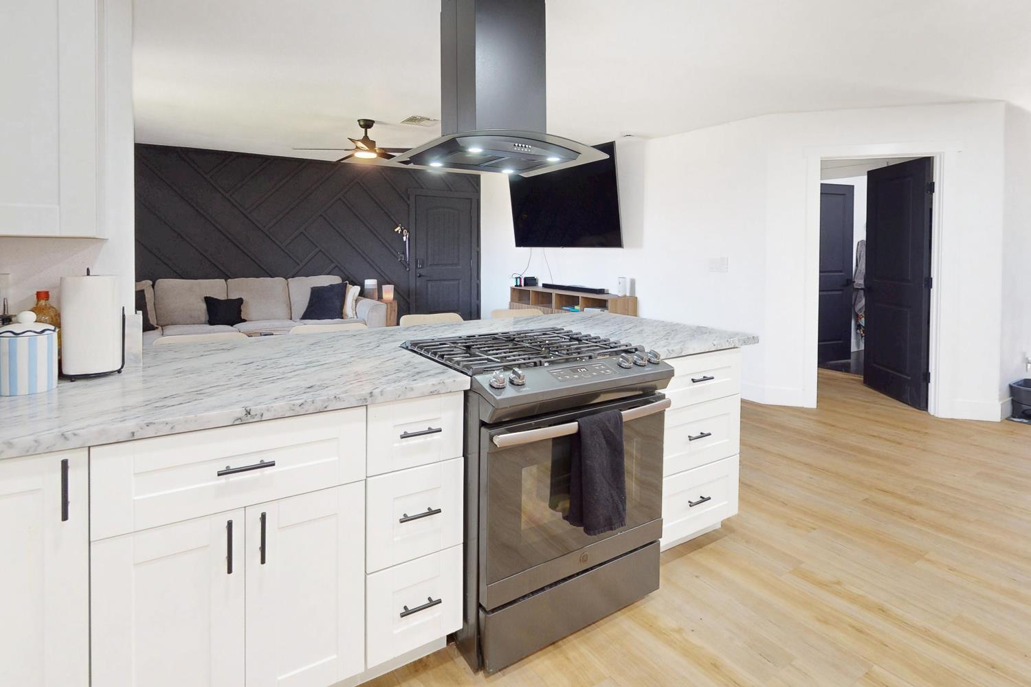 894 Grand Oroville, CA 95965 - Photo 18 of 49 a kitchen with granite countertop a stove and a sink