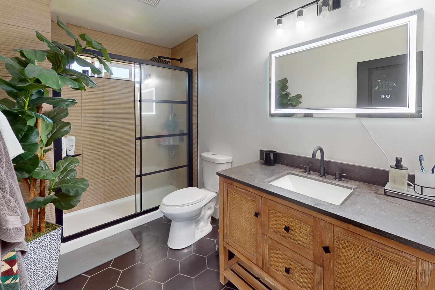 894 Grand Oroville, CA 95965 - Photo 21 of 49 a bathroom with a granite countertop sink toilet and shower