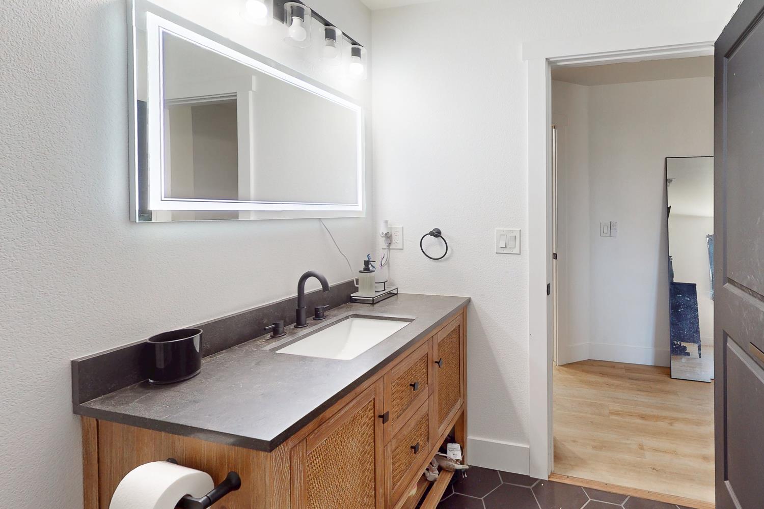 894 Grand Oroville, CA 95965 - Photo 22 of 49 a bathroom with a sink vanity and a mirror