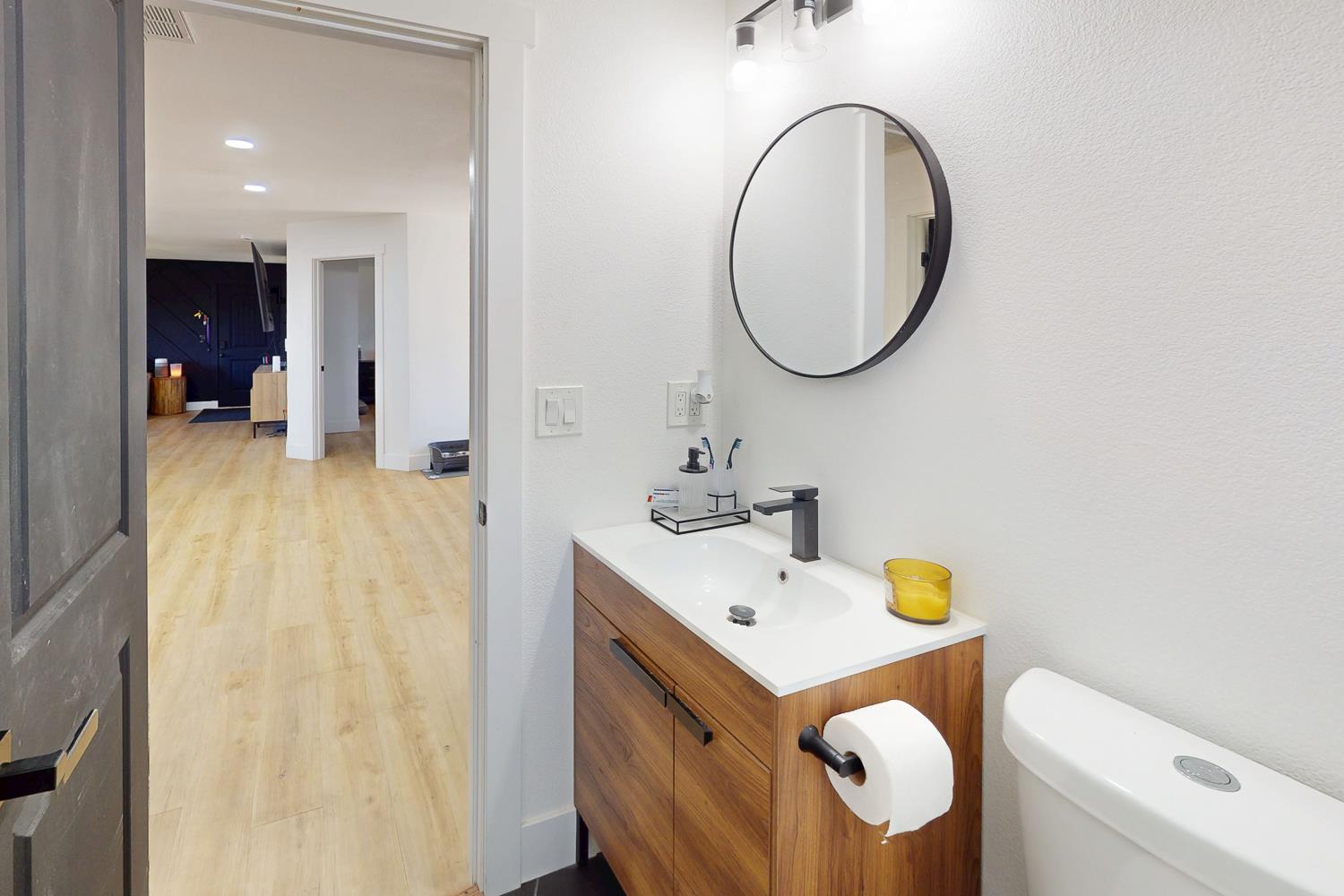 894 Grand Oroville, CA 95965 - Photo 23 of 49 a bathroom with a sink mirror and toilet