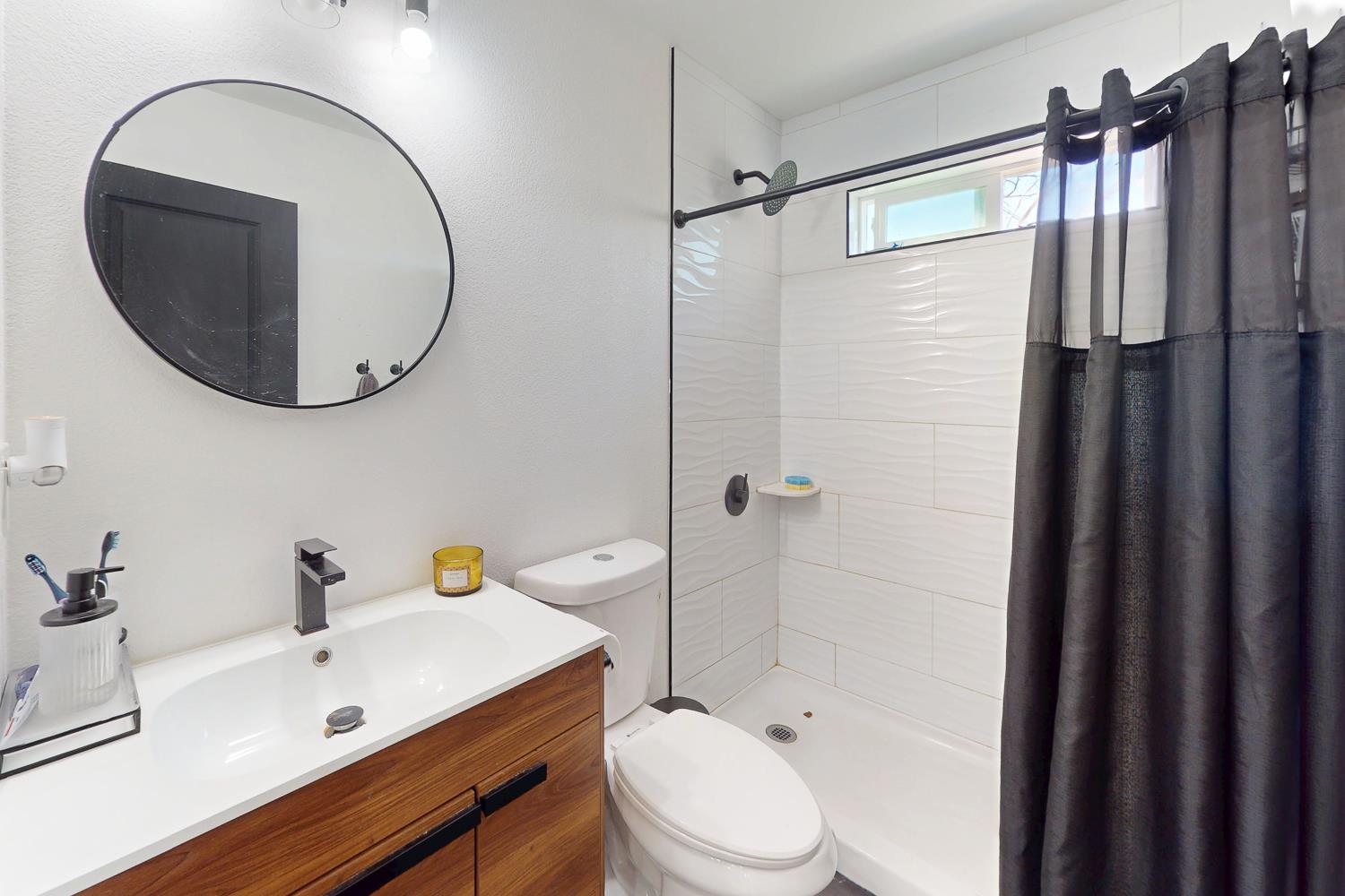 894 Grand Oroville, CA 95965 - Photo 24 of 49 a bathroom with a sink a toilet a mirror and shower