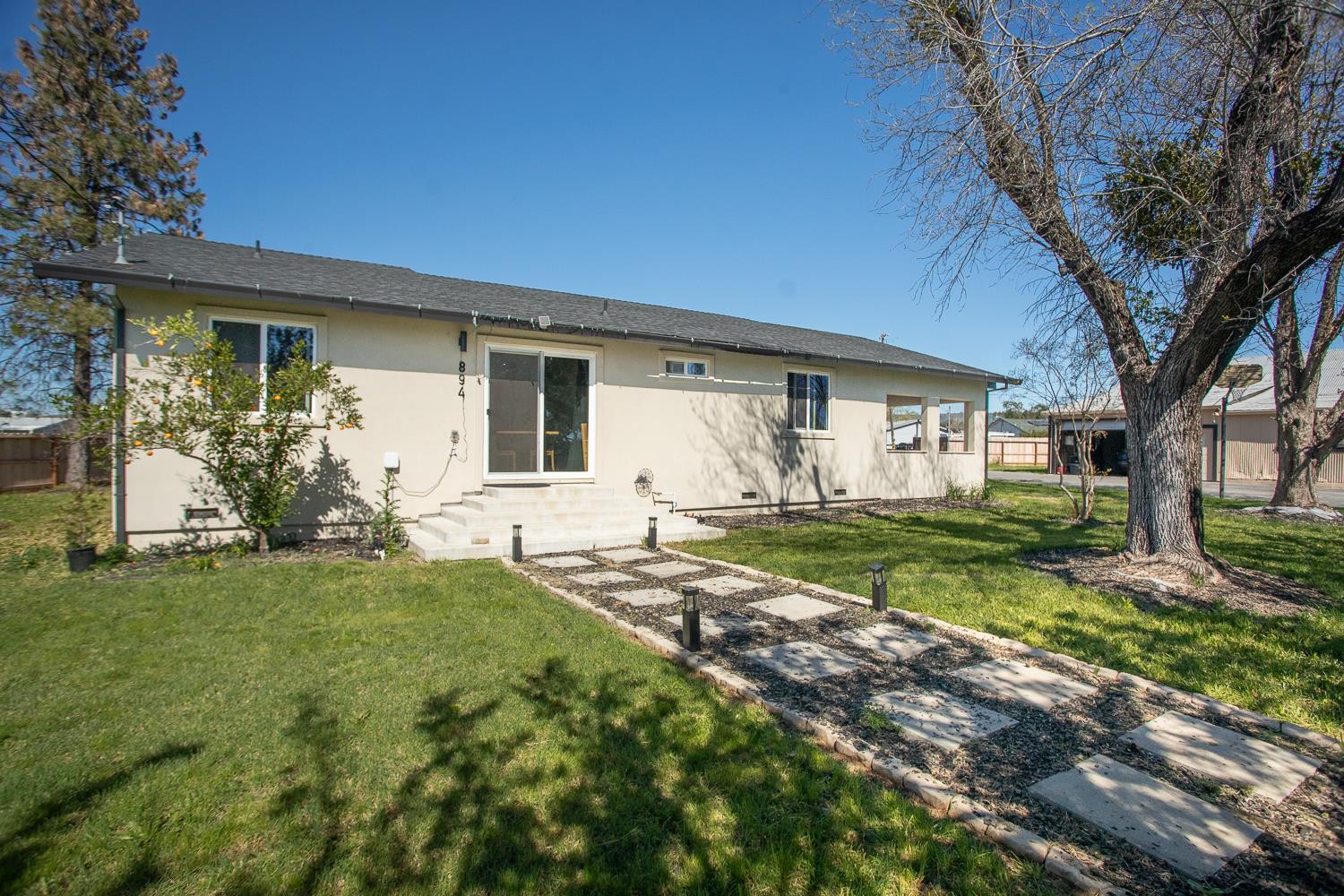 894 Grand Oroville, CA 95965 - Photo 8 of 49 a view of a house with backyard and a tree