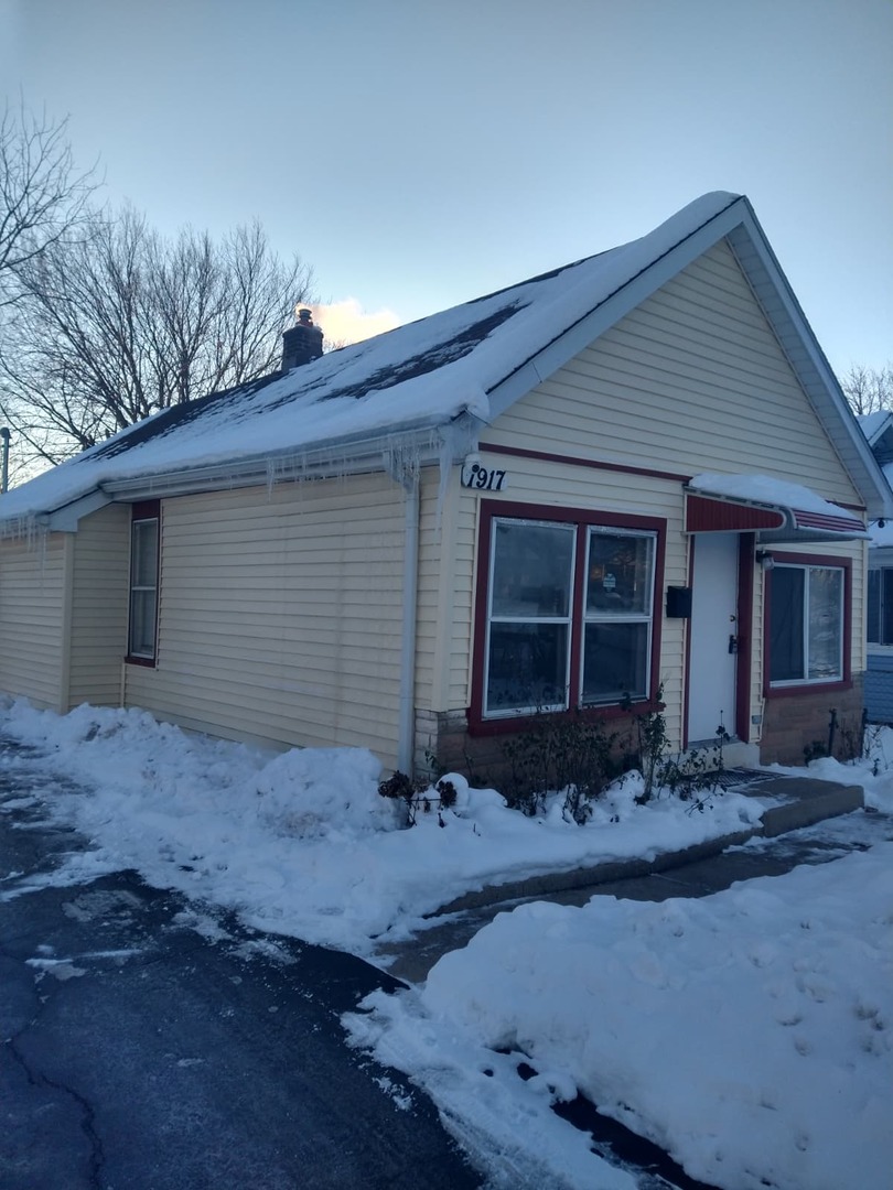1917 Honore Avenue North Chicago, IL 60064 - Photo 1 of 27 a front view of a house with garden