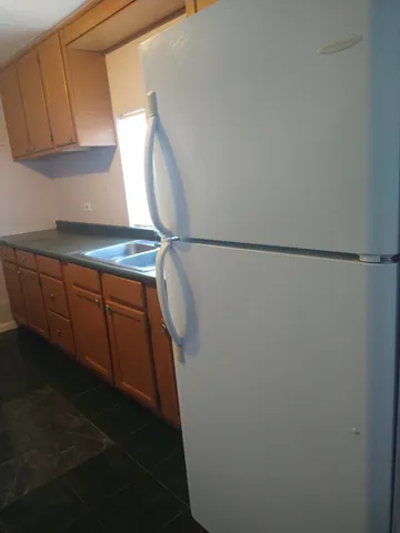 a kitchen with granite countertop a stove and a microwave