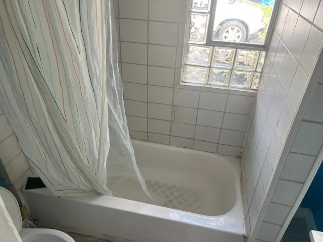 a bathroom with a bathtub and window