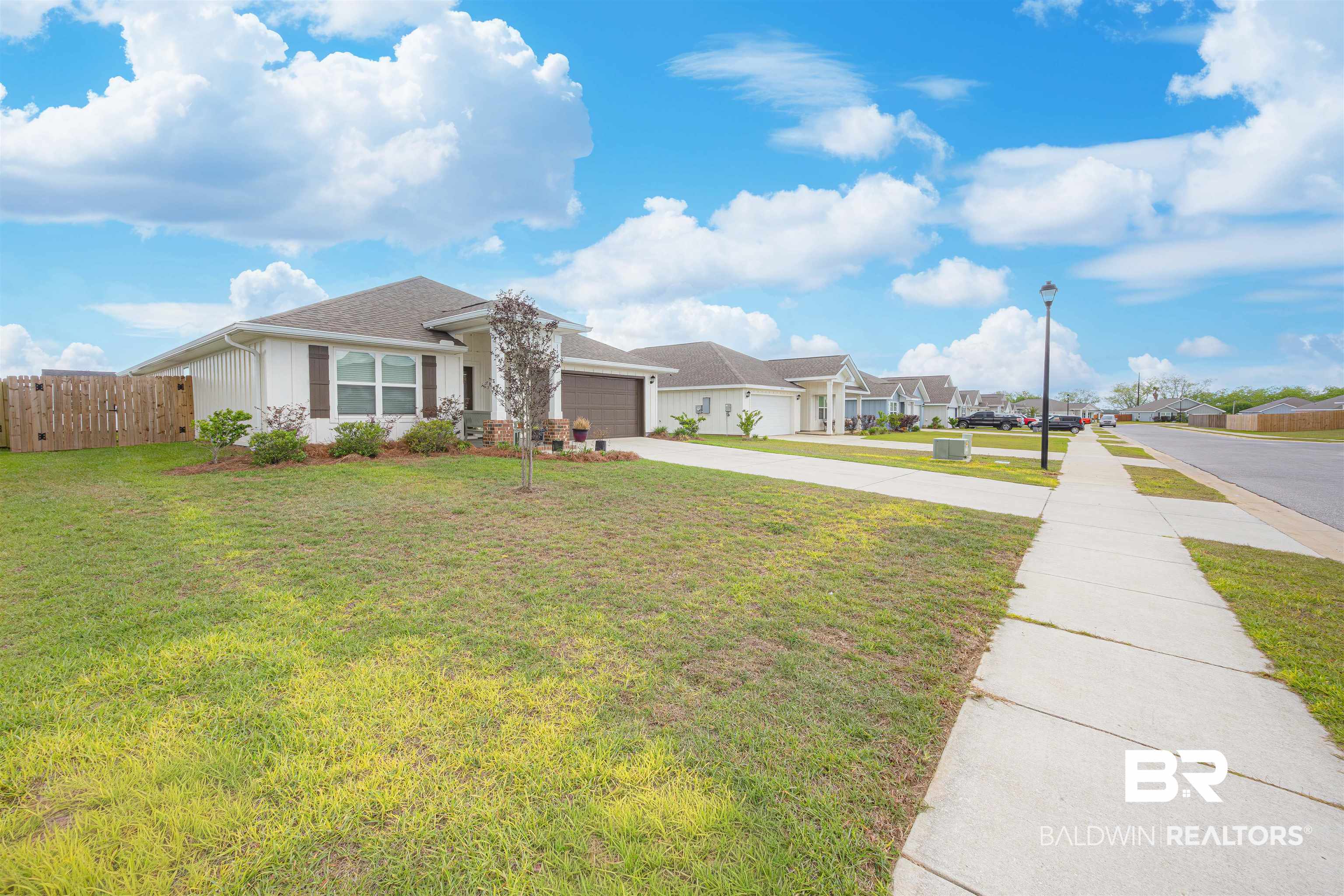 14843 Forsythia Loop Silverhill, AL 36576 - Photo 3 of 51 Ranch-style home with driveway, a garage, and a residential view
