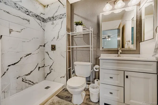 a bathroom with a sink toilet and shower