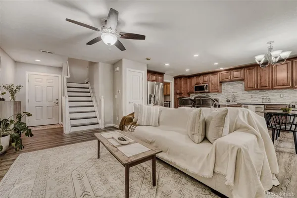 a living room with furniture and kitchen view
