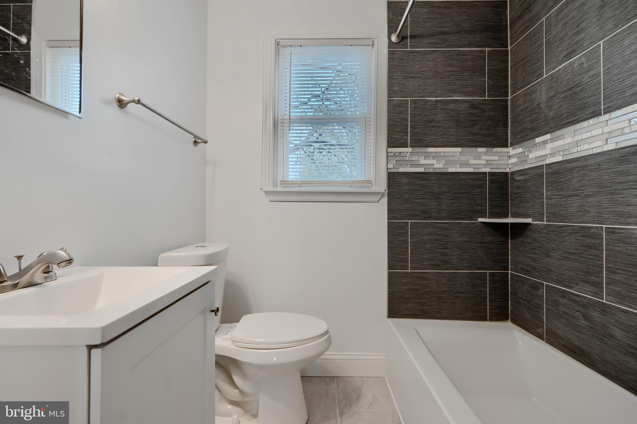 1632 Riverwood Road Baltimore, MD 21221 - Photo 12 of 32 a bathroom with a sink a toilet and shower
