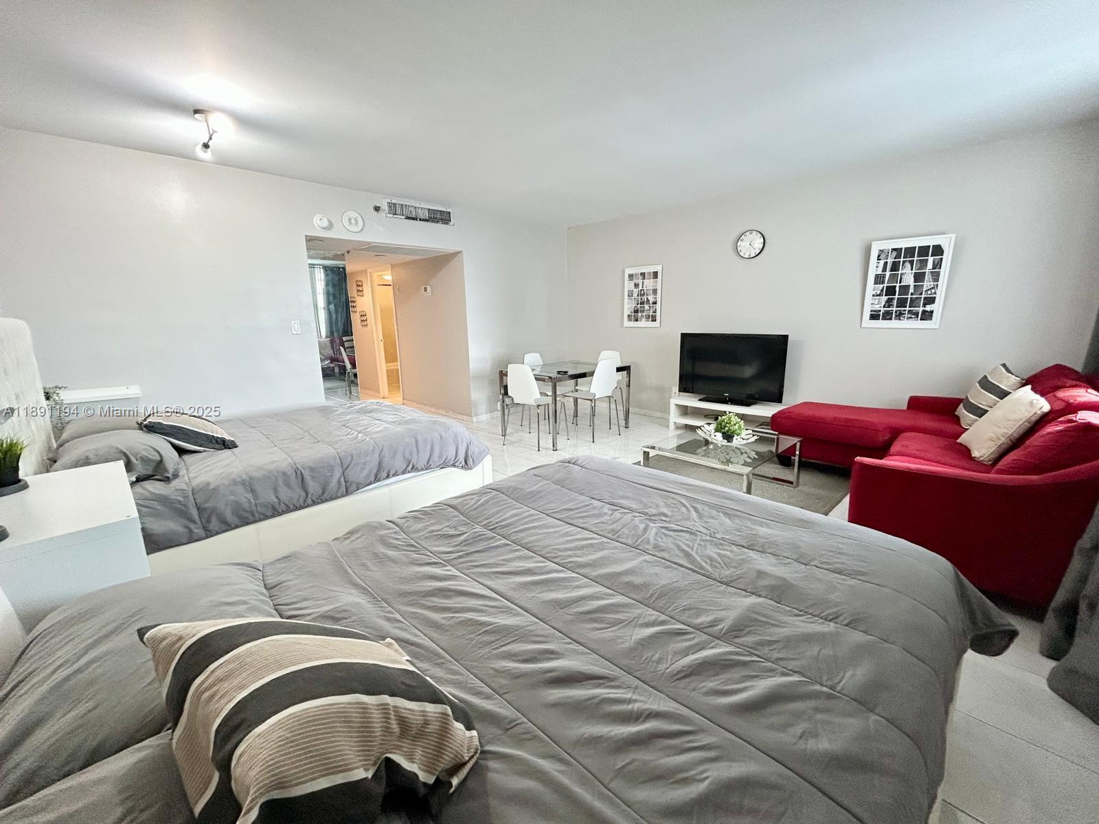 100 Lincoln Road, Unit 1616 Miami Beach, FL 33139 - Photo 2 of 7 a bedroom with a bed and wooden floor