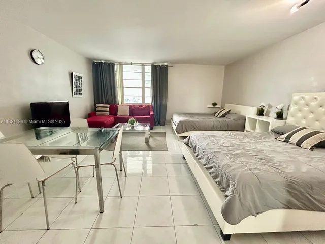 a spacious bedroom with a bed and window