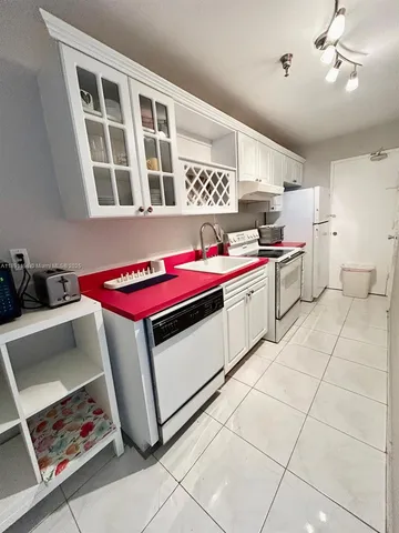 a kitchen with a stove top oven and cabinets