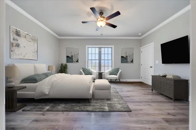 a spacious bedroom with a bed couch and a flat screen tv