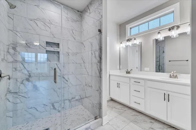 a bathroom with a double vanity sink and mirror