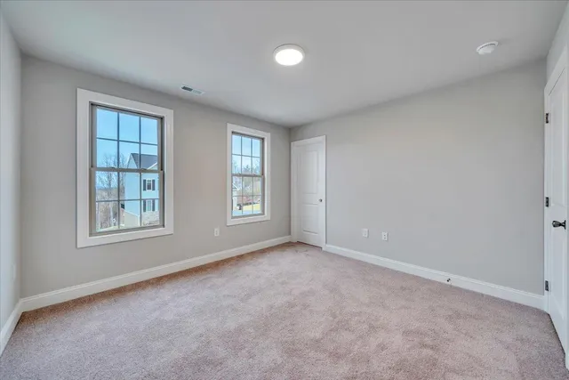 an empty room with windows & closet