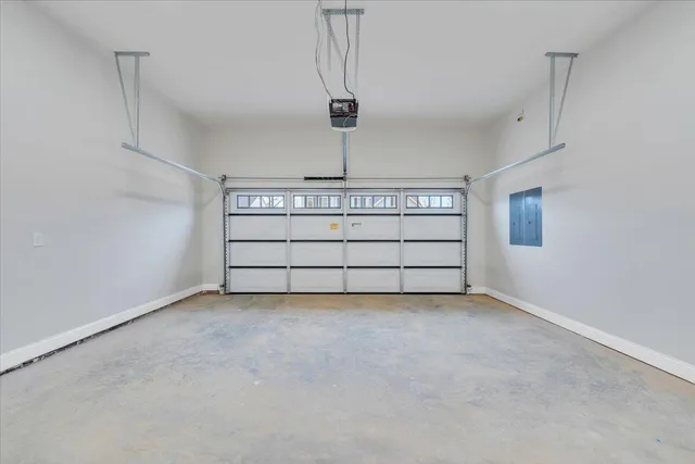 a view of empty room with window and wooden floor
