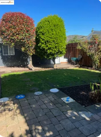 a view of a garden with a building in the background