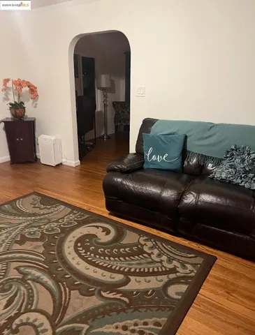 a living room with a couch and a rug