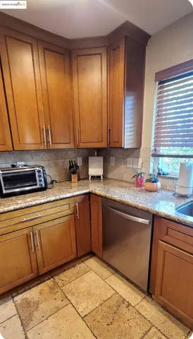 a kitchen with stainless steel appliances granite countertop a sink and a cabinets