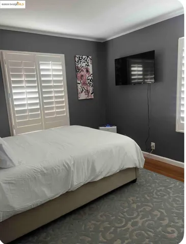 a bedroom with a bed and a flat screen tv