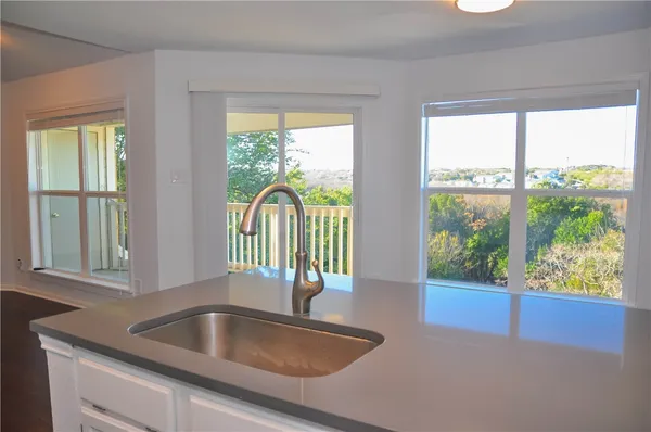 a kitchen with a sink and a large window