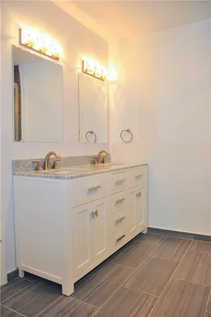 a bathroom with a double vanity sink and mirror